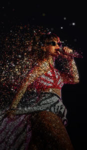 Rihanna singing into a microphone at Wembley