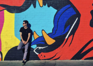 Carl Wills infront of graphic wall